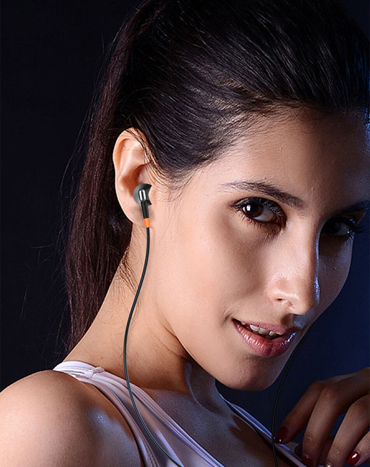 Woman wearing wireless earbuds with a dark background