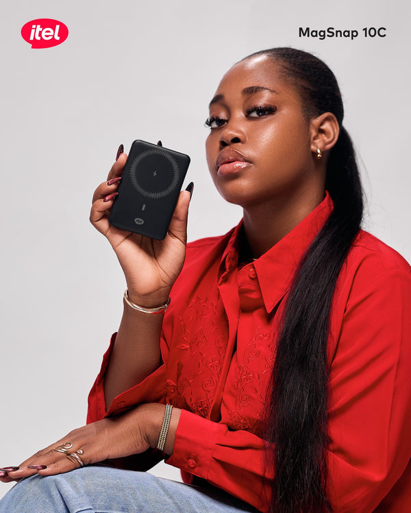 Woman holding an itel MagSnap 10C device against a plain background