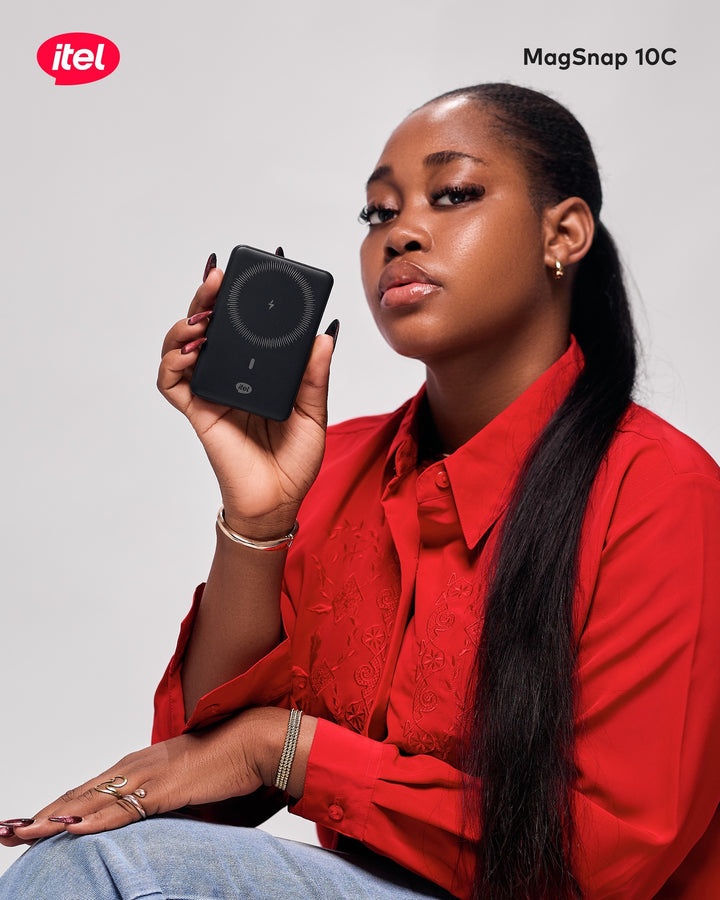 Woman holding an itel MagSnap 10C device against a plain background