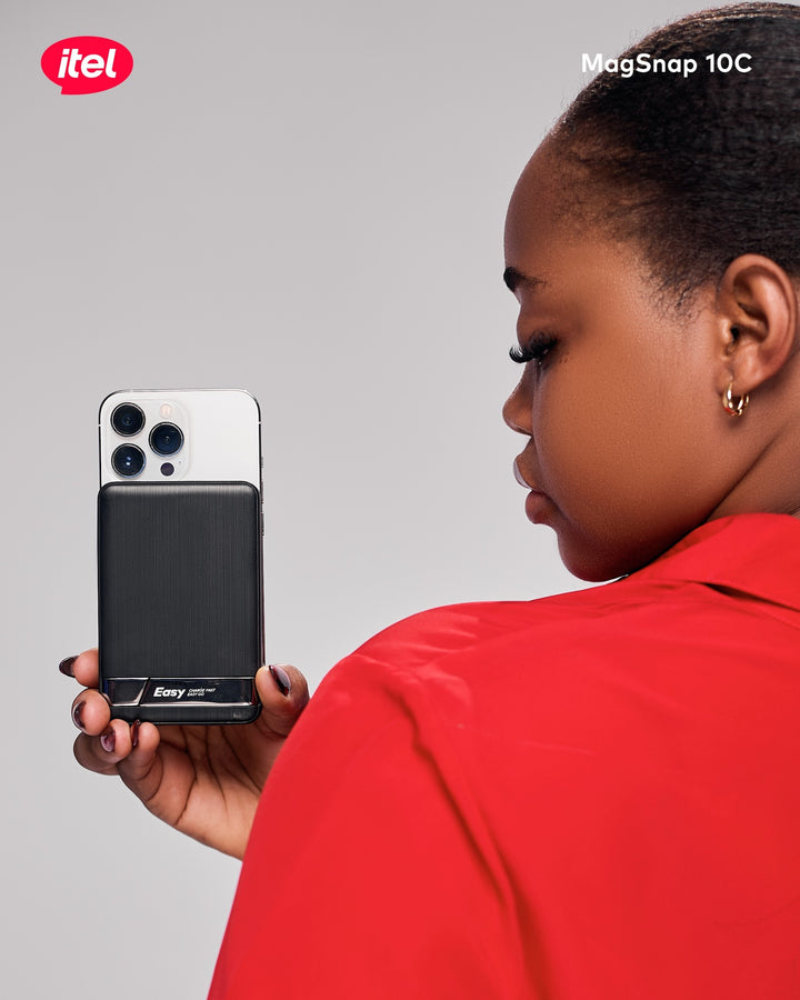 Person holding an itel phone with a gray background